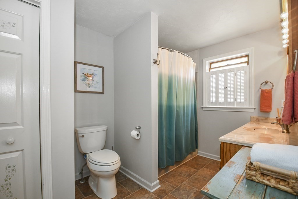 60 Peabody Road, Unit B Shirley, MA 01464 - Photo 16 of 42 a bathroom with a toilet a sink and a window