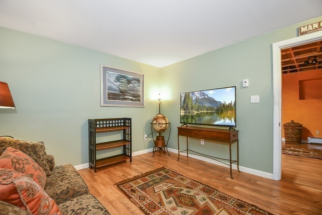 60 Peabody Road, Unit B Shirley, MA 01464 - Photo 24 of 42 a bedroom with a bed and a dresser next to a window