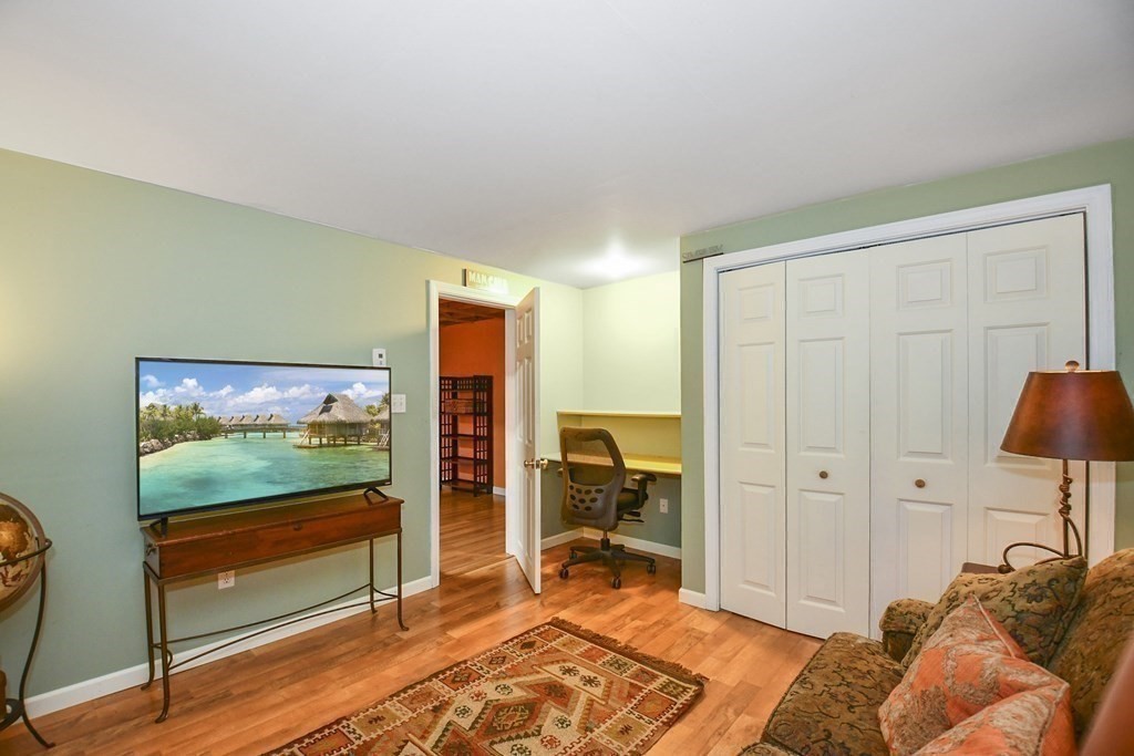 60 Peabody Road, Unit B Shirley, MA 01464 - Photo 25 of 42 a bedroom with a bed and a television