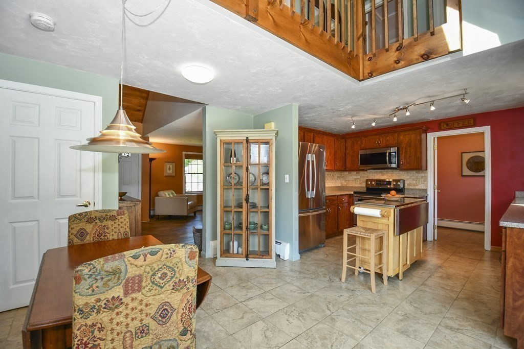 60 Peabody Road, Unit B Shirley, MA 01464 - Photo 5 of 42 a kitchen with stainless steel appliances kitchen island granite countertop a refrigerator and a stove top oven