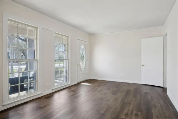 a view of wooden floor and windows in a room