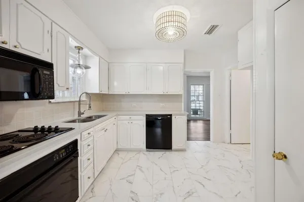 a kitchen with stainless steel appliances granite countertop a stove and a sink