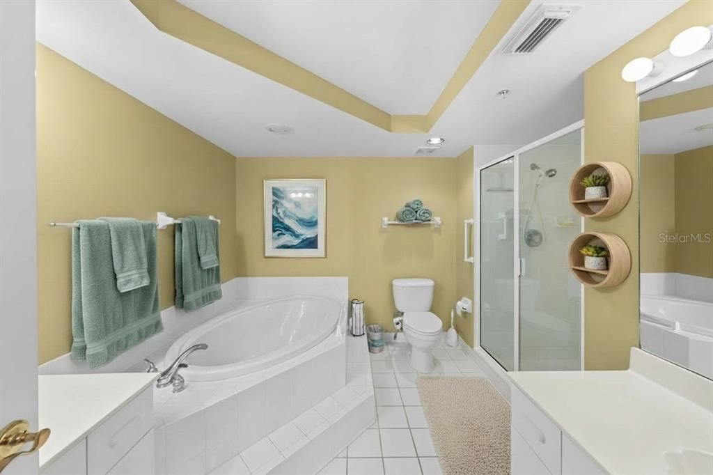 4575 South Atlantic Avenue, Unit 6209 Ponce Inlet, FL 32127 - Photo 14 of 31 a spacious bathroom with a tub sink and a mirror