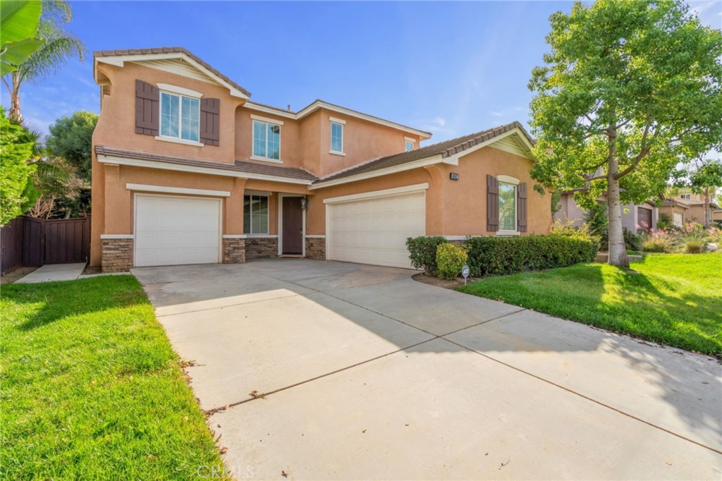 a front view of a house with a yard and garage
