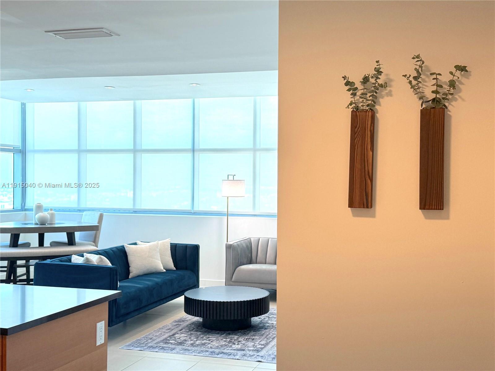 3301 Northeast 1st Avenue, Unit H3001 Miami, FL 33137 - Photo 11 of 53 a living room with furniture and a potted plant