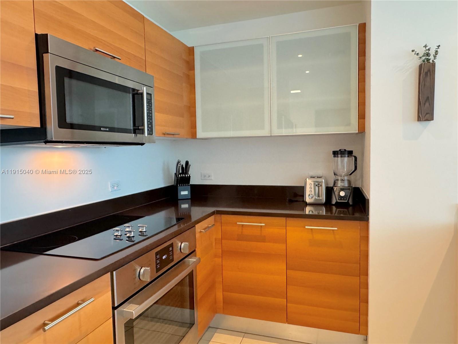 3301 Northeast 1st Avenue, Unit H3001 Miami, FL 33137 - Photo 13 of 53 a kitchen with a sink and a microwave
