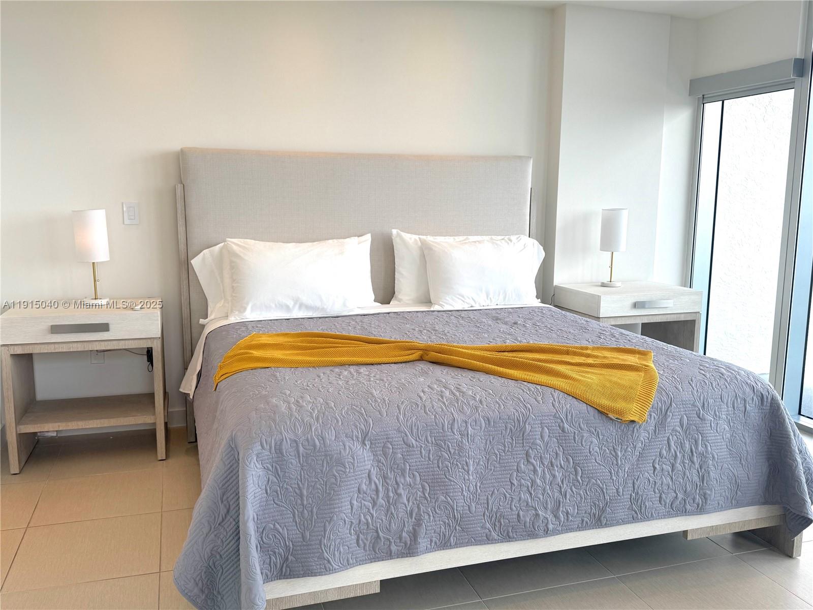 3301 Northeast 1st Avenue, Unit H3001 Miami, FL 33137 - Photo 16 of 53 a bedroom with a bed and lamps