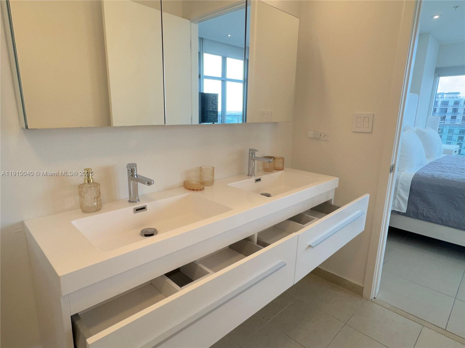 3301 Northeast 1st Avenue, Unit H3001 Miami, FL 33137 - Photo 25 of 53 a bathroom with a sink and a mirror