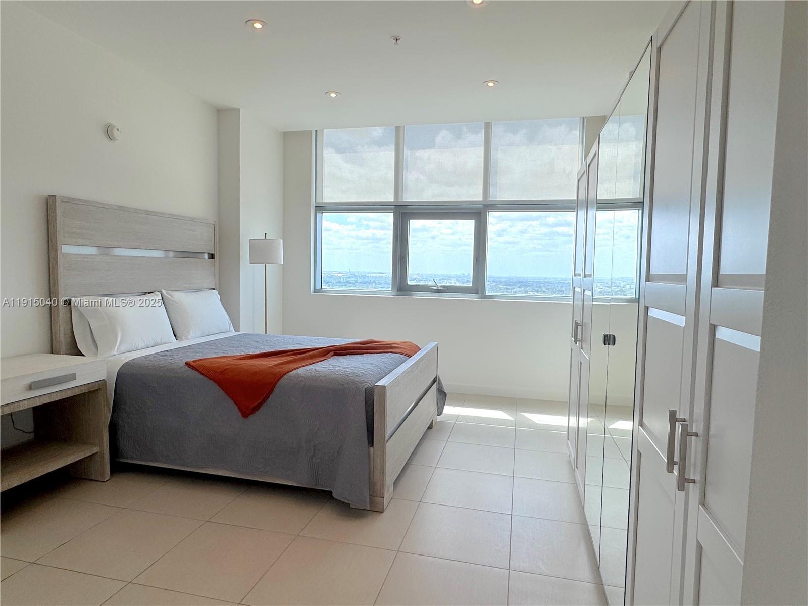 3301 Northeast 1st Avenue, Unit H3001 Miami, FL 33137 - Photo 35 of 53 a bedroom with a bed and a window