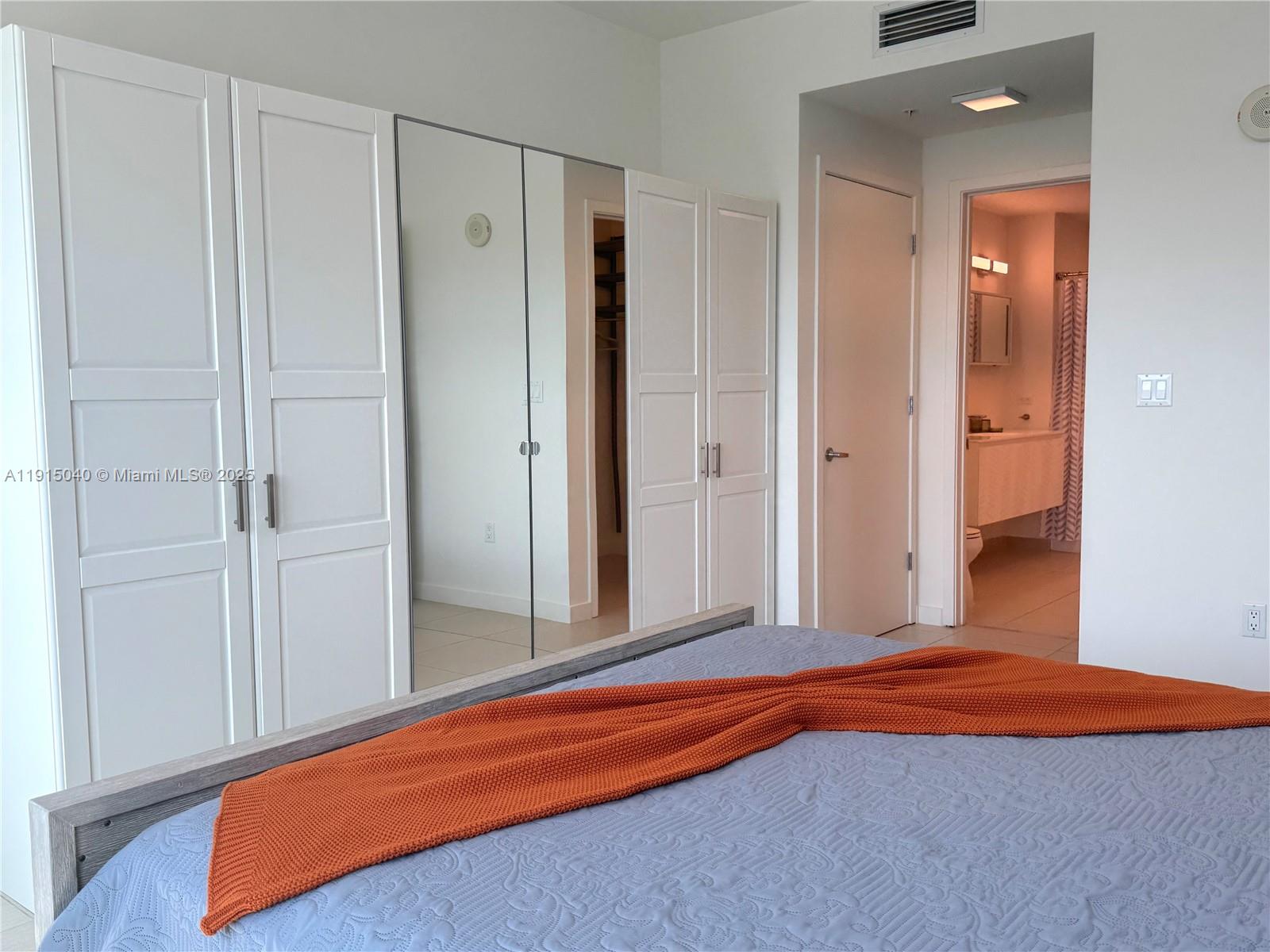 3301 Northeast 1st Avenue, Unit H3001 Miami, FL 33137 - Photo 36 of 53 a bedroom with a bed and a closet