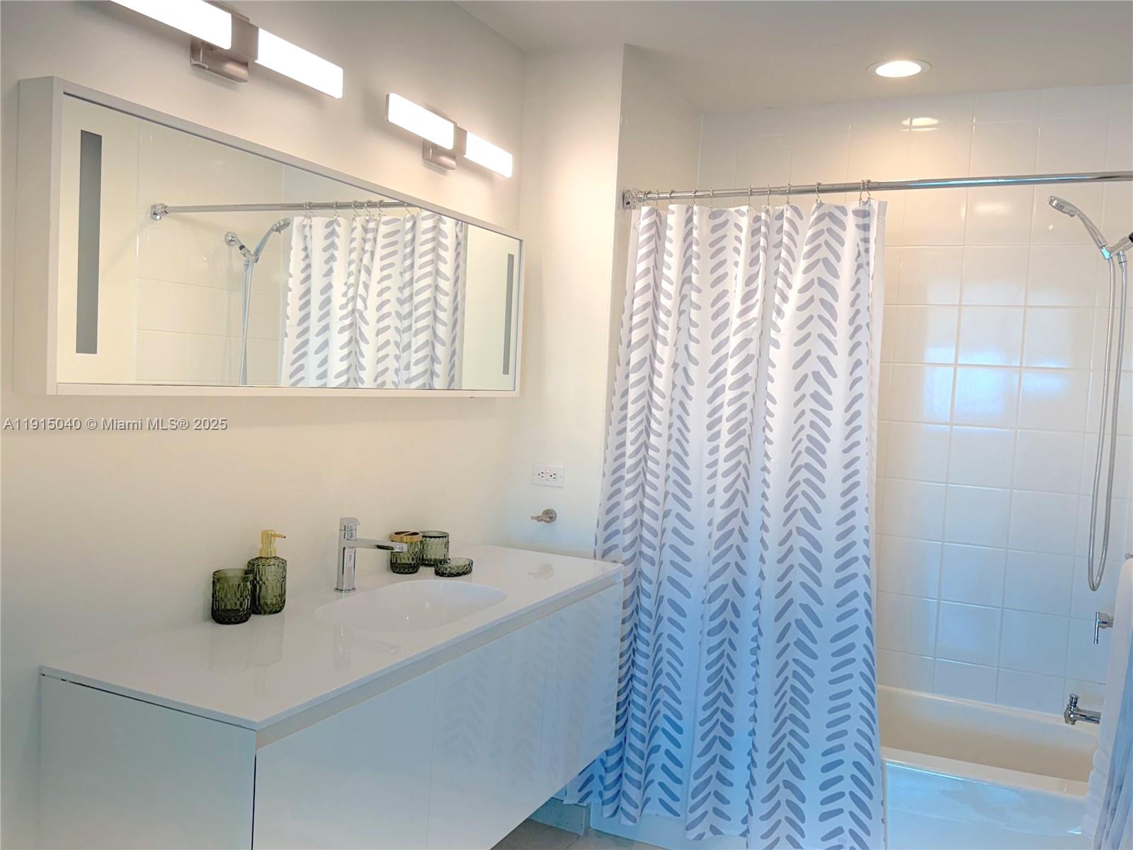 3301 Northeast 1st Avenue, Unit H3001 Miami, FL 33137 - Photo 37 of 53 a bathroom with a sink and a mirror