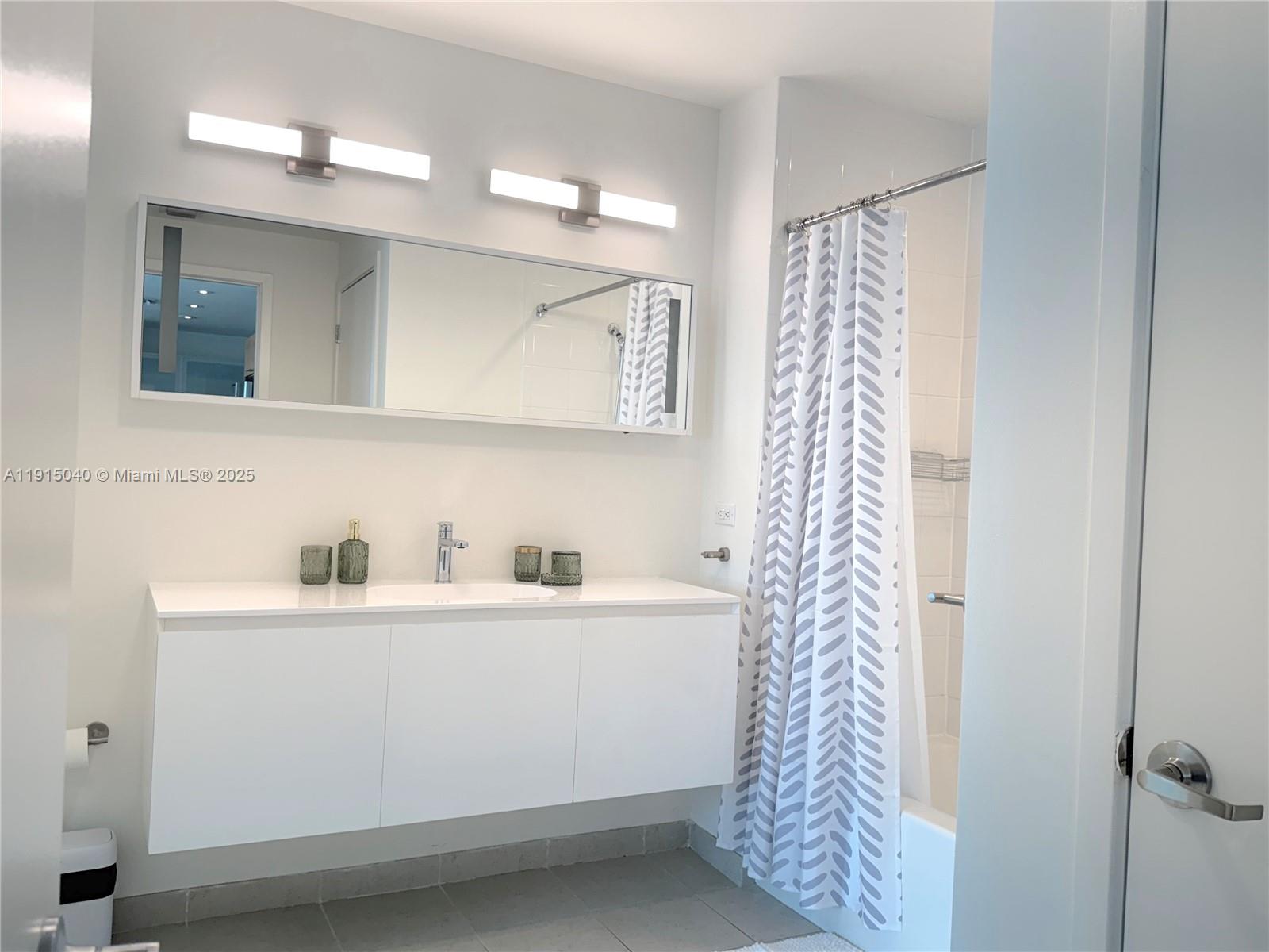 3301 Northeast 1st Avenue, Unit H3001 Miami, FL 33137 - Photo 38 of 53 a bathroom with a sink a toilet and a mirror