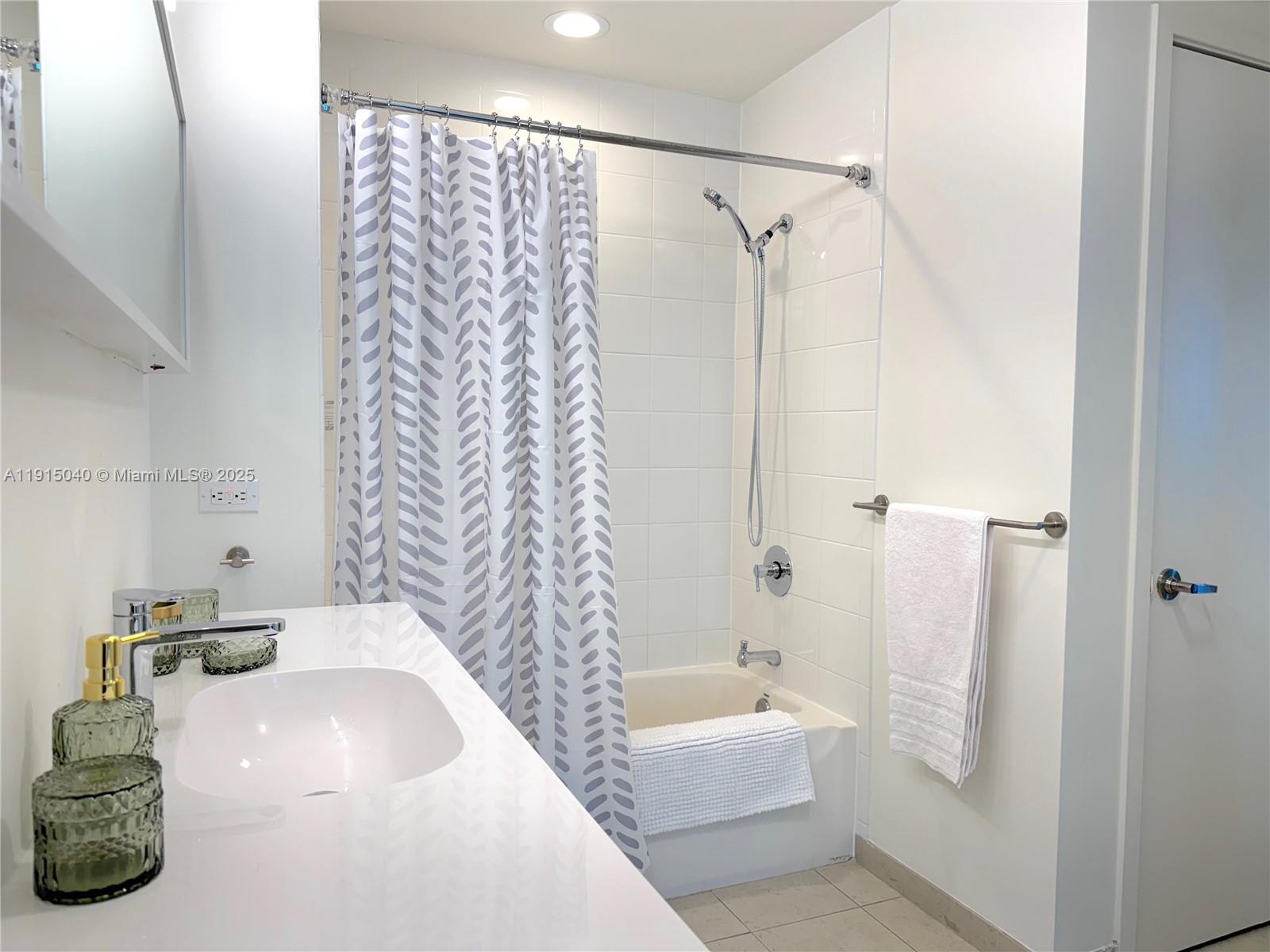 3301 Northeast 1st Avenue, Unit H3001 Miami, FL 33137 - Photo 39 of 53 a bathroom with a tub a sink and shower