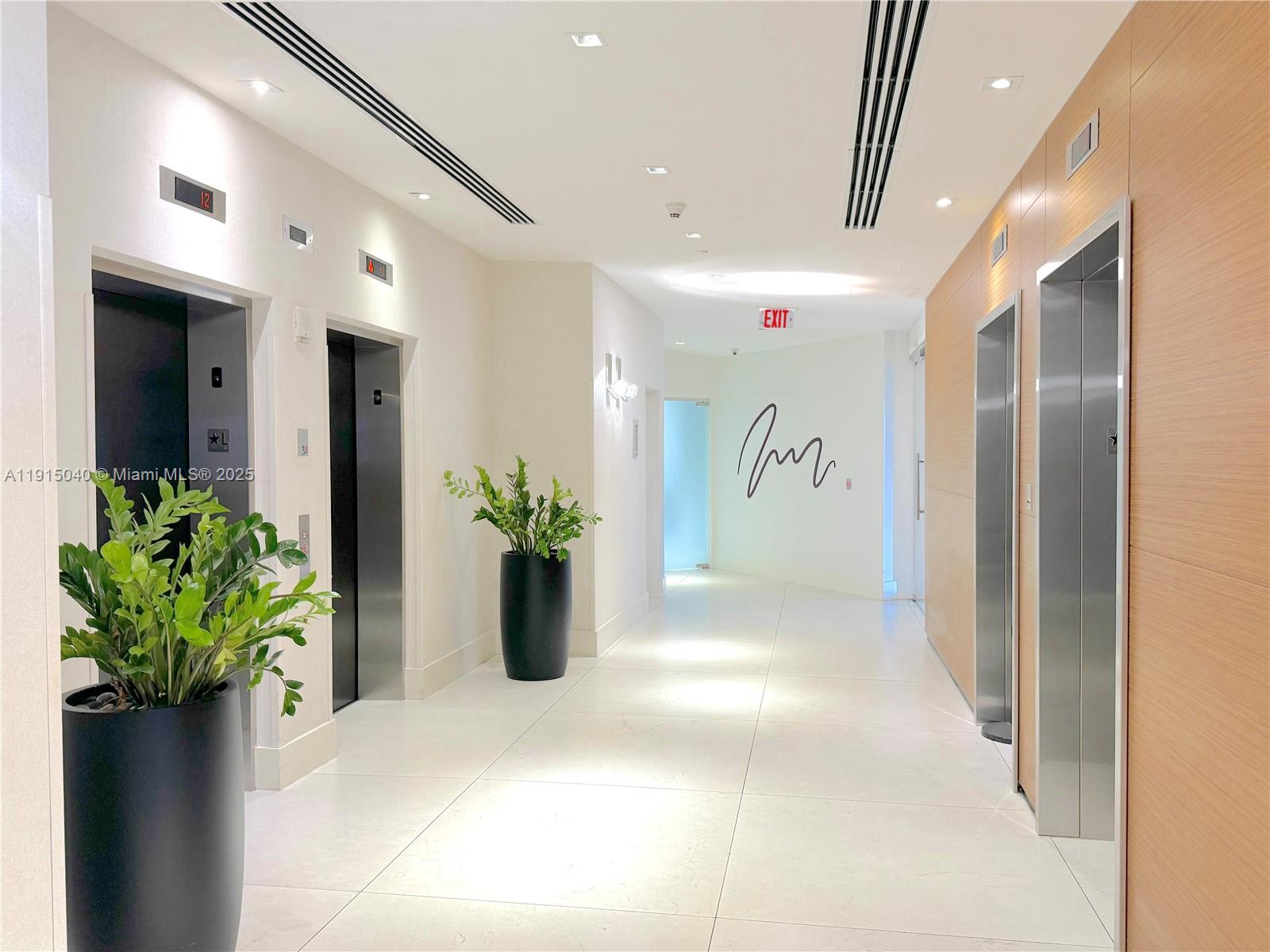 3301 Northeast 1st Avenue, Unit H3001 Miami, FL 33137 - Photo 4 of 53 a view of a hallway with potted plant