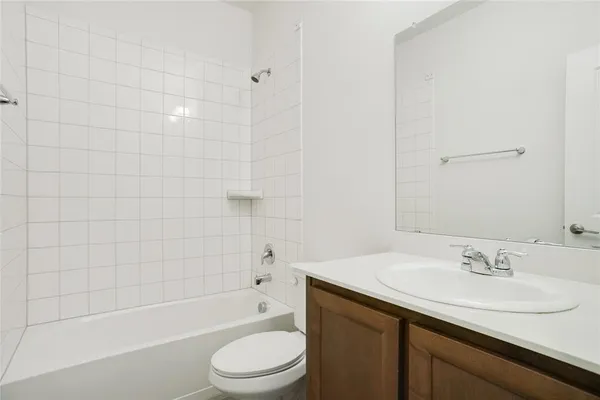 a bathroom with a granite countertop sink a mirror and shower