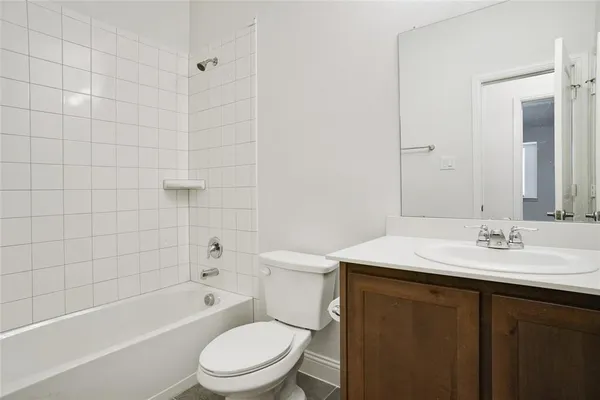 an empty room with wooden floor chandelier fan and windows