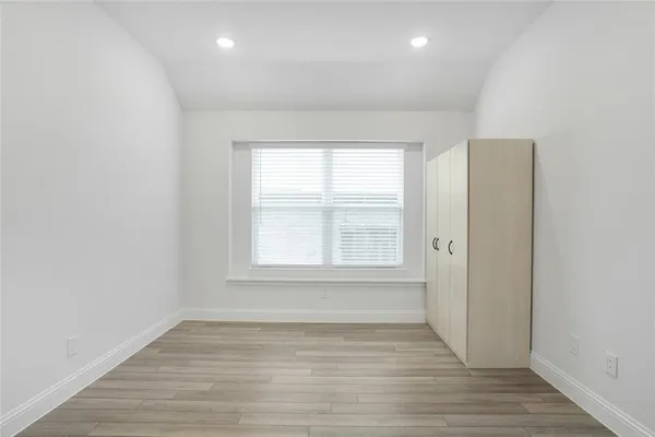 a large kitchen with stainless steel appliances a large counter top a stove and a wooden floors