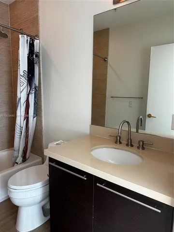 a view of walk in closet with clothes