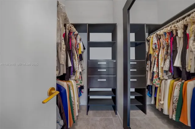 a view of walk in closet with empty racks