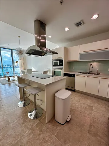 a kitchen with a sink stainless steel appliances and cabinets