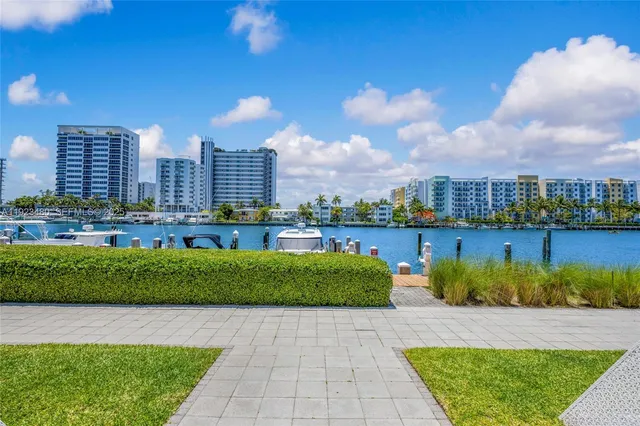 a view of a house with a yard and potted plants