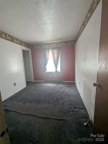 en empty room with windows and yard