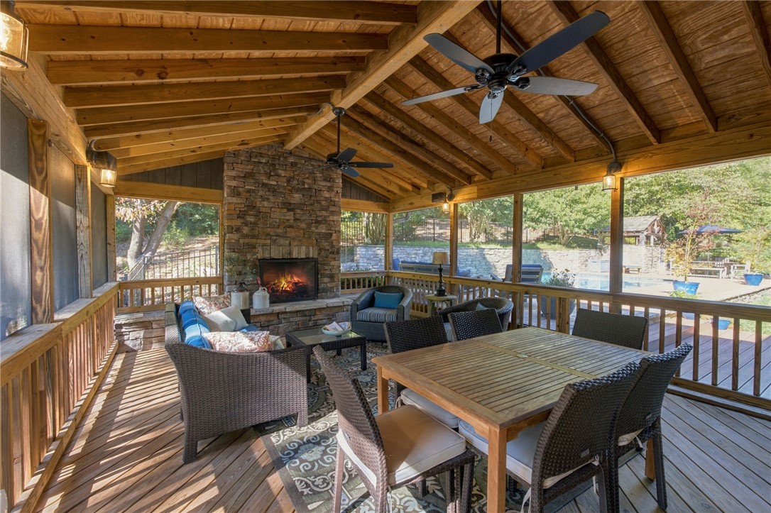 604 Ridgecrest Drive Clemson, SC 29631 - Photo 45 of 50 An inviting stone fireplace anchors this spacious screened porch with wood plank decking.