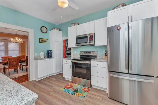 a living room with a couch a table and a chandelier