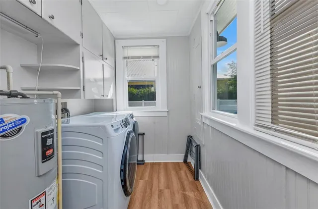 a view of a swimming pool with a yard and plants
