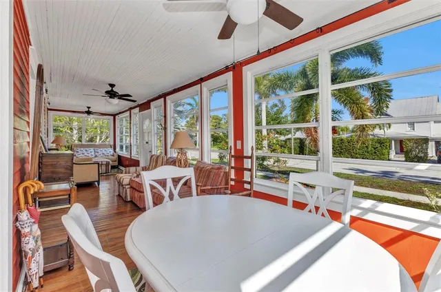 a living room with furniture a wooden floor and a chandelier