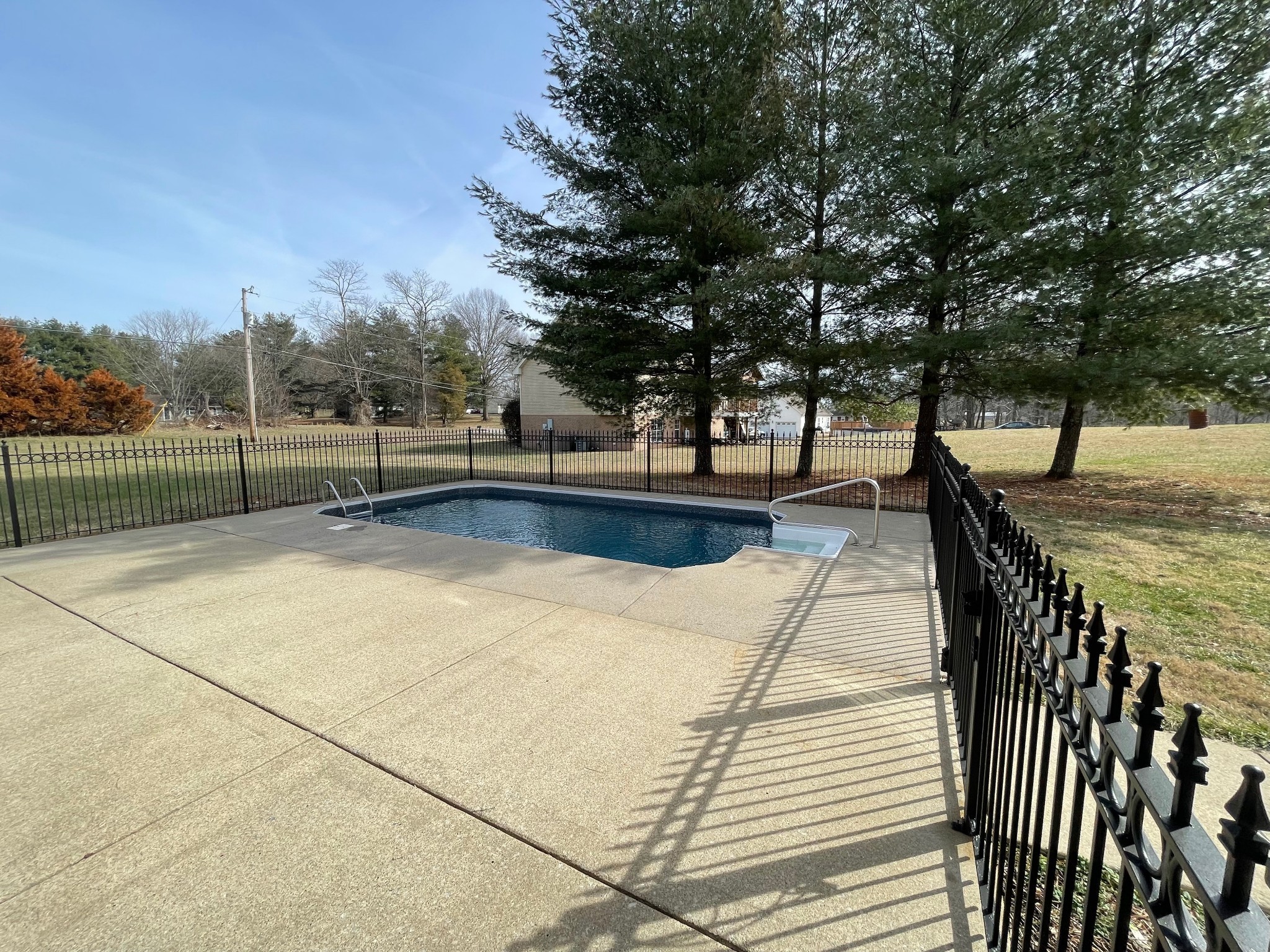 113 West Hester Road Cottontown, TN 37048 - Photo 3 of 21 a view of swimming pool with lounge chair and dinning table under an umbrella