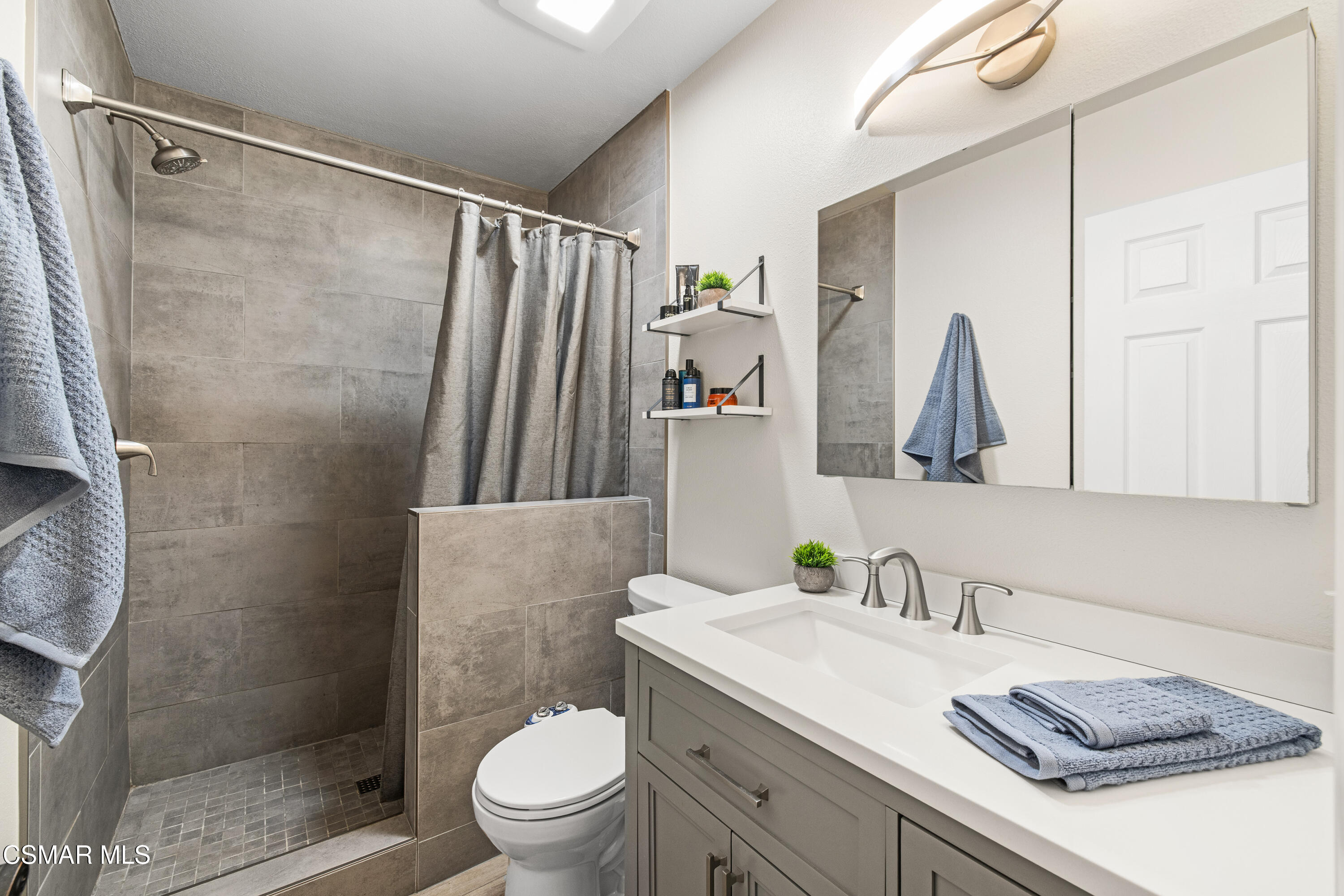5200 Prairieview Street Camarillo, CA 93012 - Photo 11 of 24 a bathroom with a granite countertop sink toilet and shower