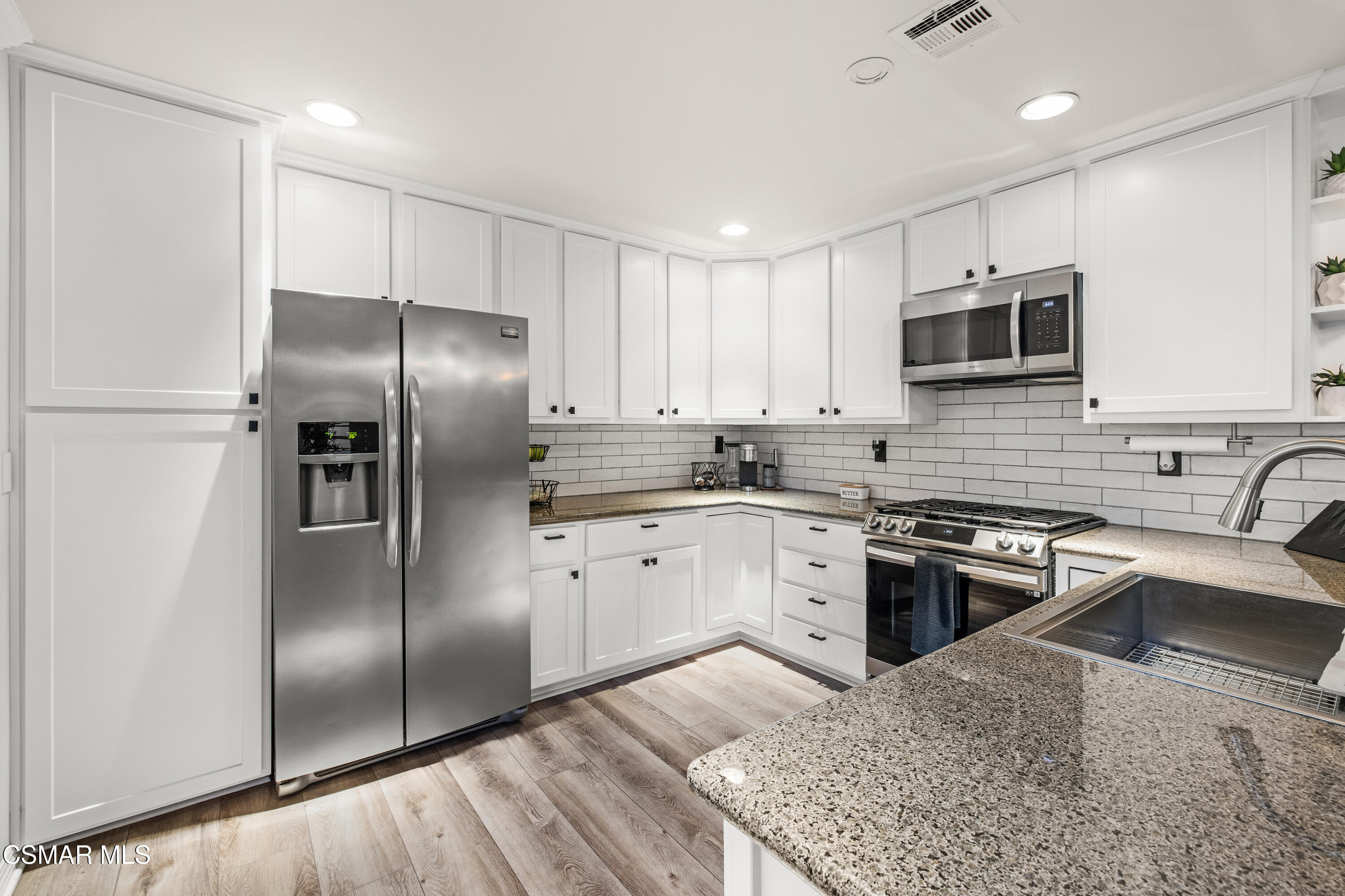 5200 Prairieview Street Camarillo, CA 93012 - Photo 6 of 24 a kitchen with stainless steel appliances granite countertop a refrigerator a stove a sink and a microwave
