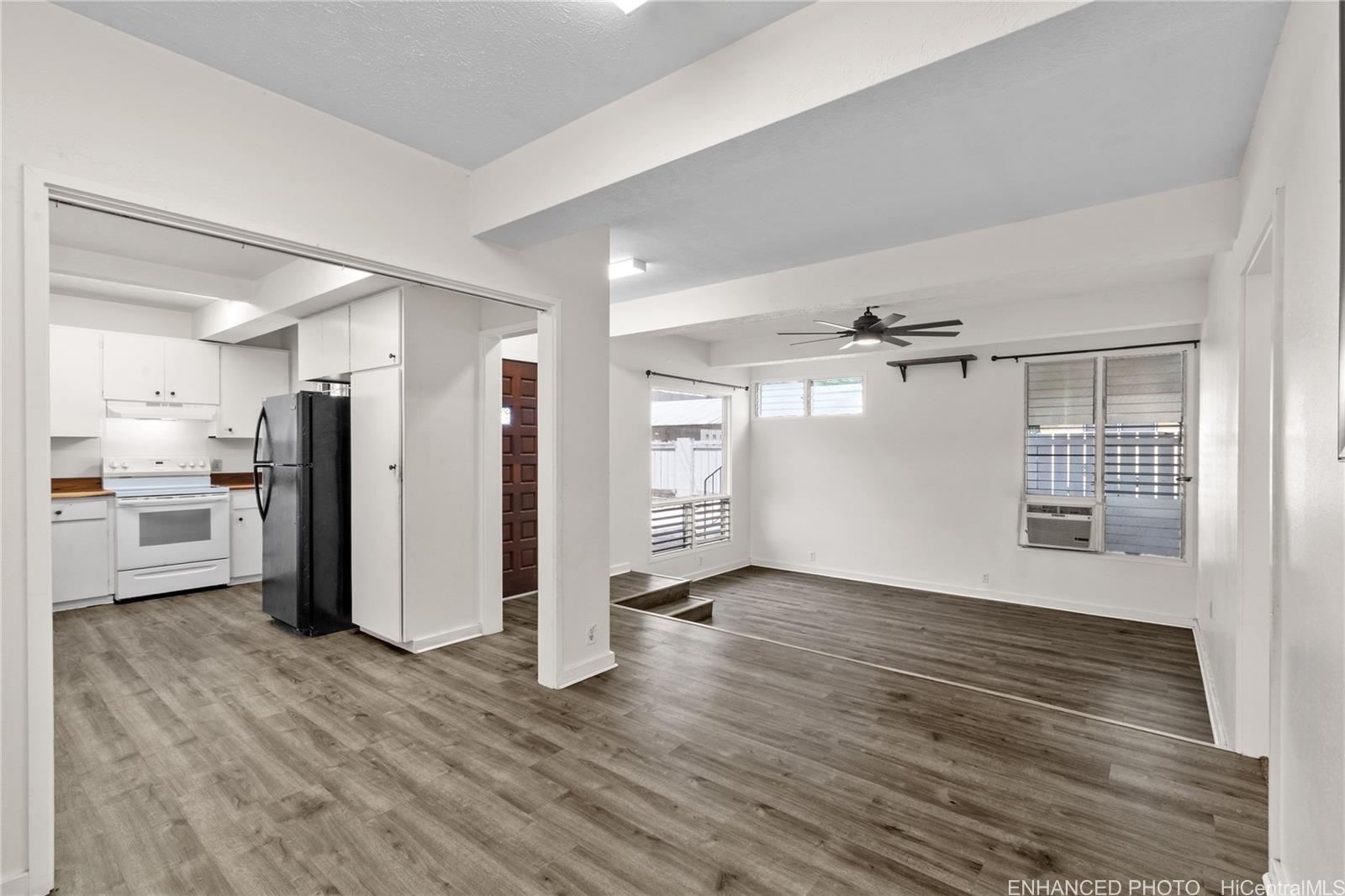 385 Kuliouou Road, Unit A Honolulu, HI 96821 - Photo 12 of 25 a view of a big room with wooden floor and a kitchen