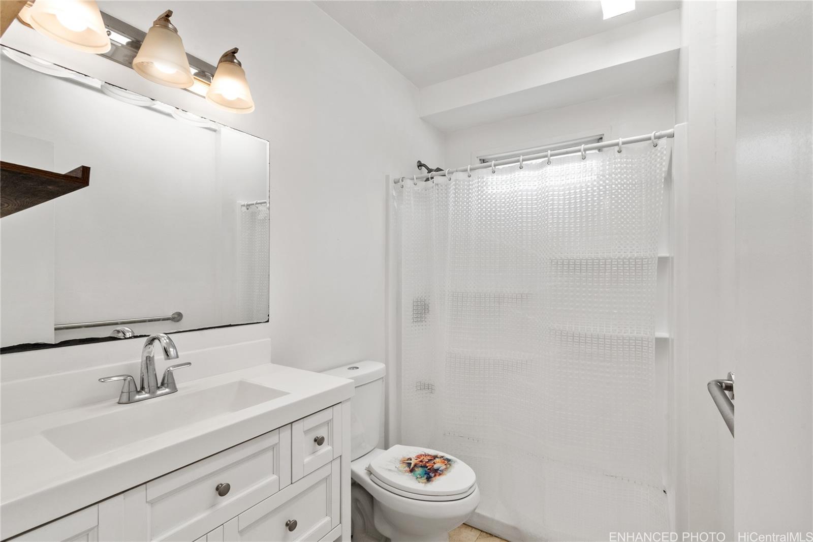 385 Kuliouou Road, Unit A Honolulu, HI 96821 - Photo 17 of 25 a bathroom with a sink toilet a mirror and shower
