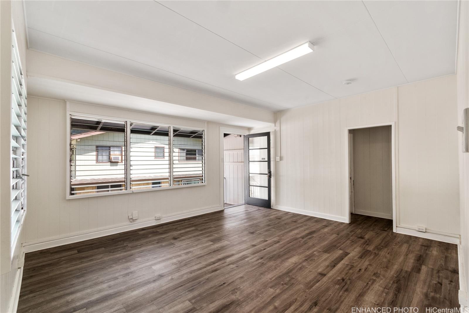 385 Kuliouou Road, Unit A Honolulu, HI 96821 - Photo 19 of 25 a view of an empty room with wooden floor and a window