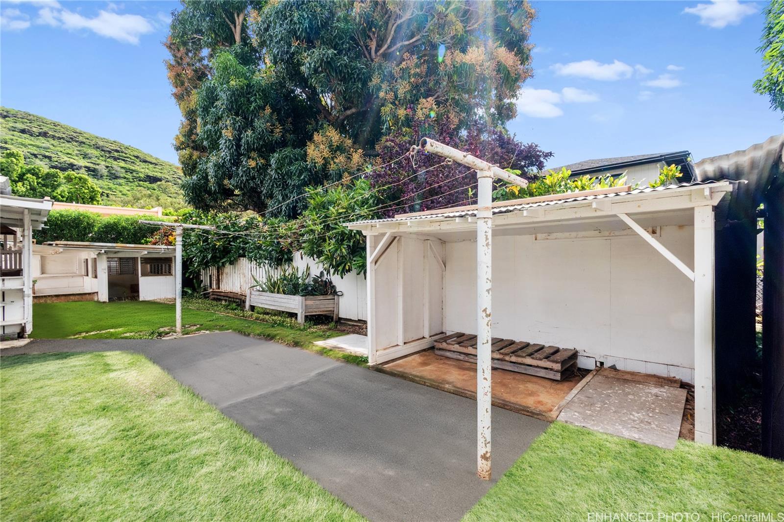 385 Kuliouou Road, Unit A Honolulu, HI 96821 - Photo 3 of 25 a view of a backyard with couches under an umbrella