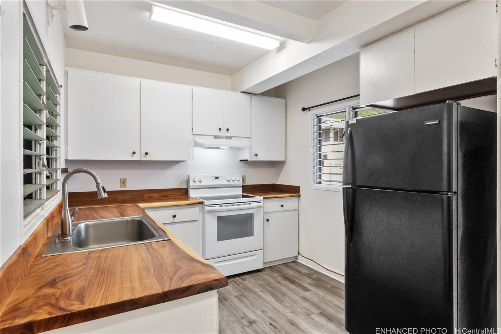 385 Kuliouou Road, Unit A Honolulu, HI 96821 - Photo 6 of 25 a kitchen with a refrigerator and a sink