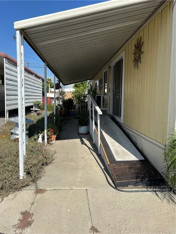 a living room with furniture and large windows