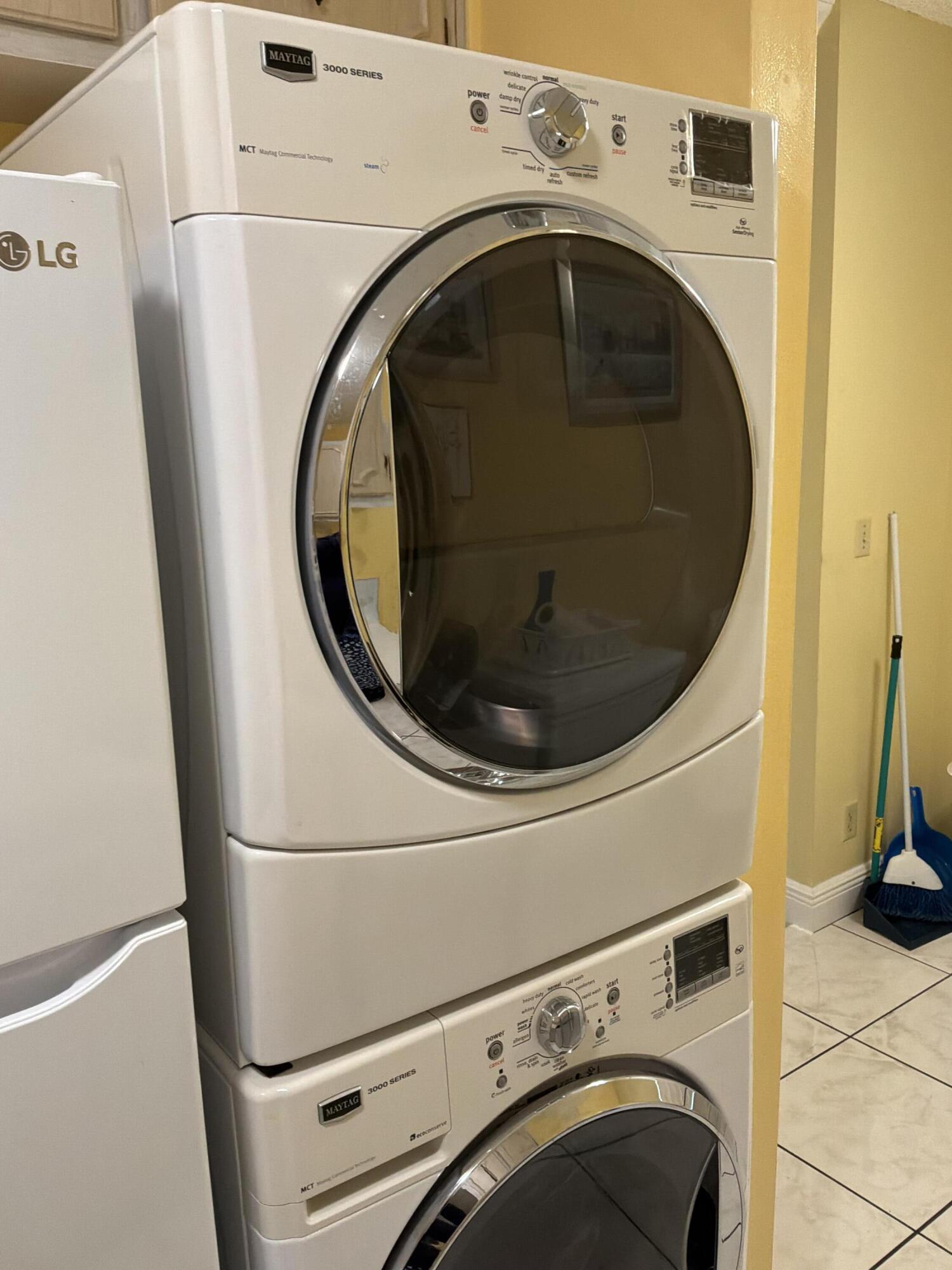 1121 Cactus Terrace, Unit 202 Delray Beach, FL 33445 - Photo 12 of 31 a utility room with dryer and washer