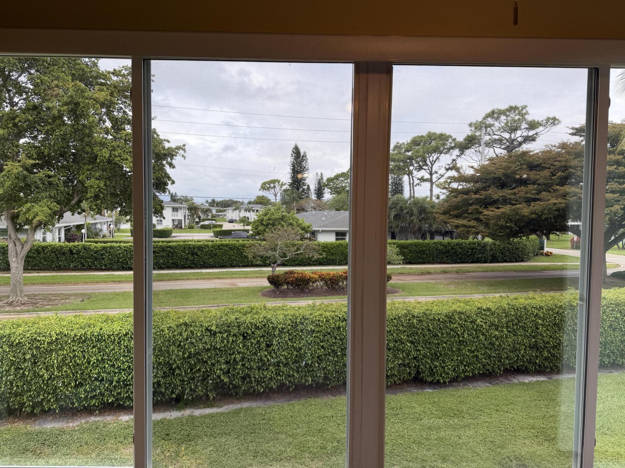 1121 Cactus Terrace, Unit 202 Delray Beach, FL 33445 - Photo 19 of 31 a view of a garden from a window