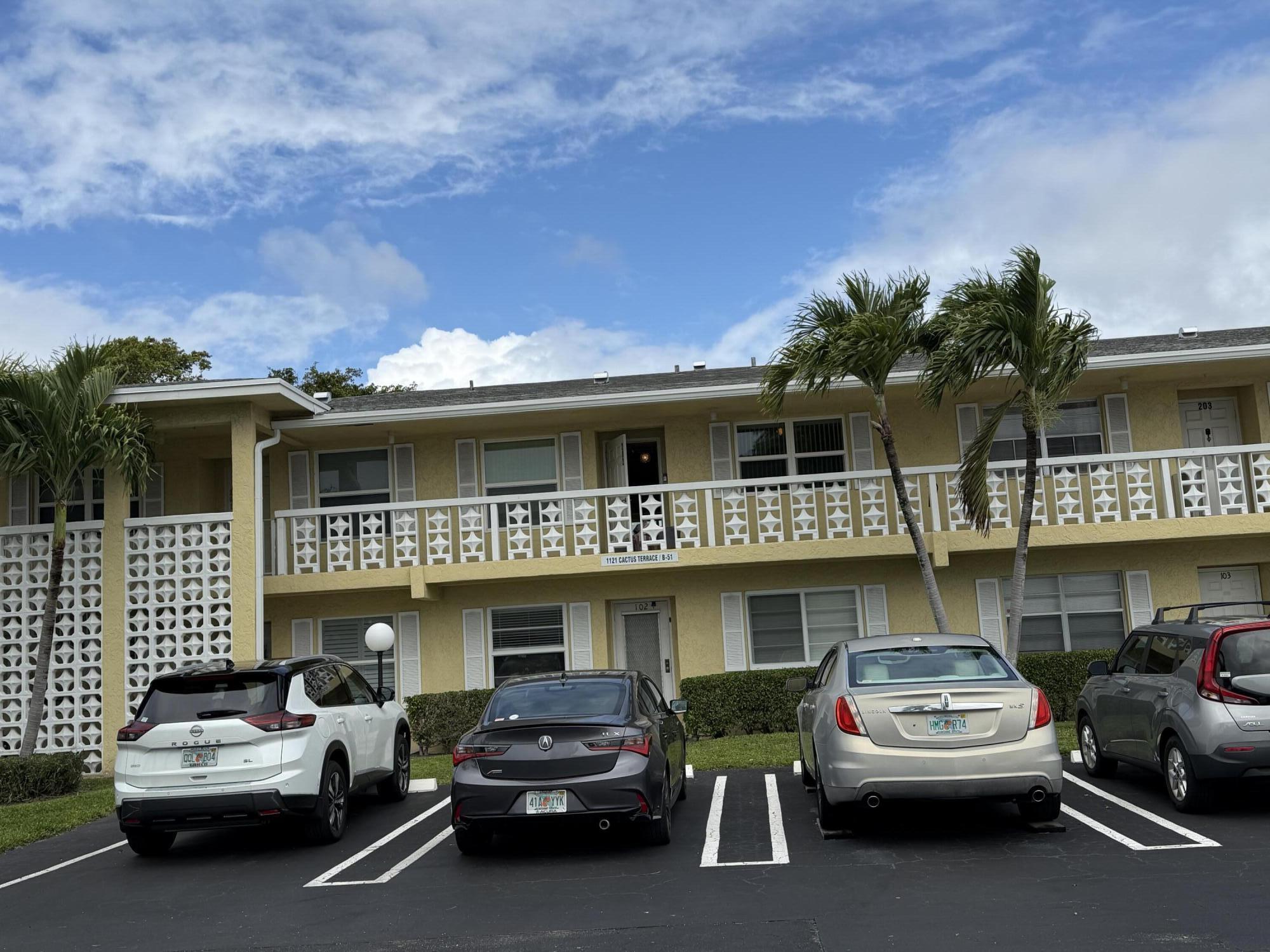 1121 Cactus Terrace, Unit 202 Delray Beach, FL 33445 - Photo 2 of 31 a view of a car park in front of house
