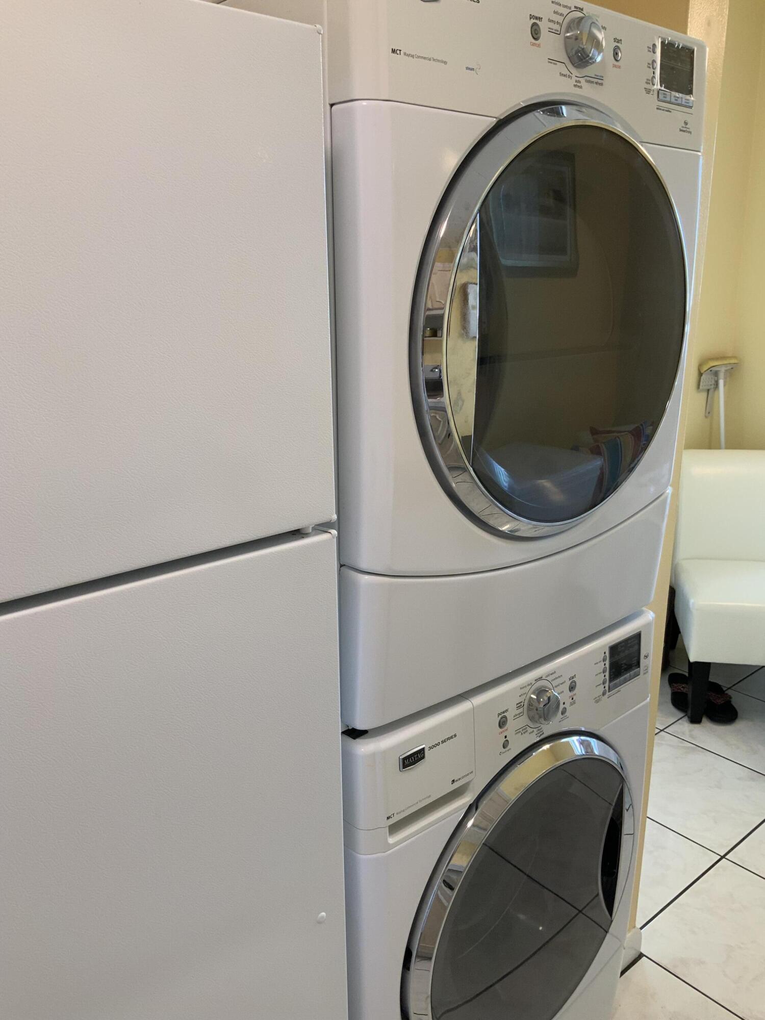 1121 Cactus Terrace, Unit 202 Delray Beach, FL 33445 - Photo 22 of 31 a utility room with dryer and washer