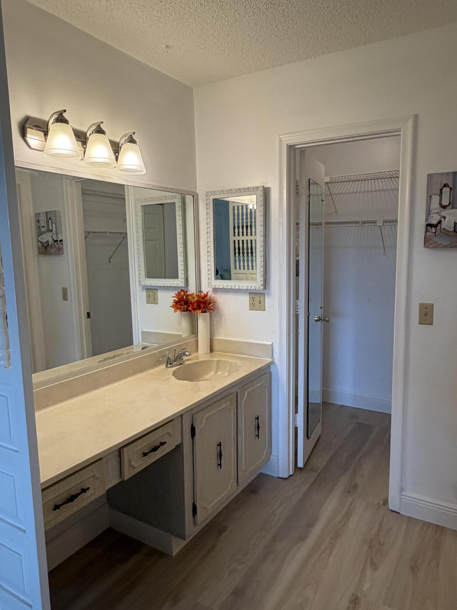 1121 Cactus Terrace, Unit 202 Delray Beach, FL 33445 - Photo 25 of 31 a bathroom with a sink and a mirror