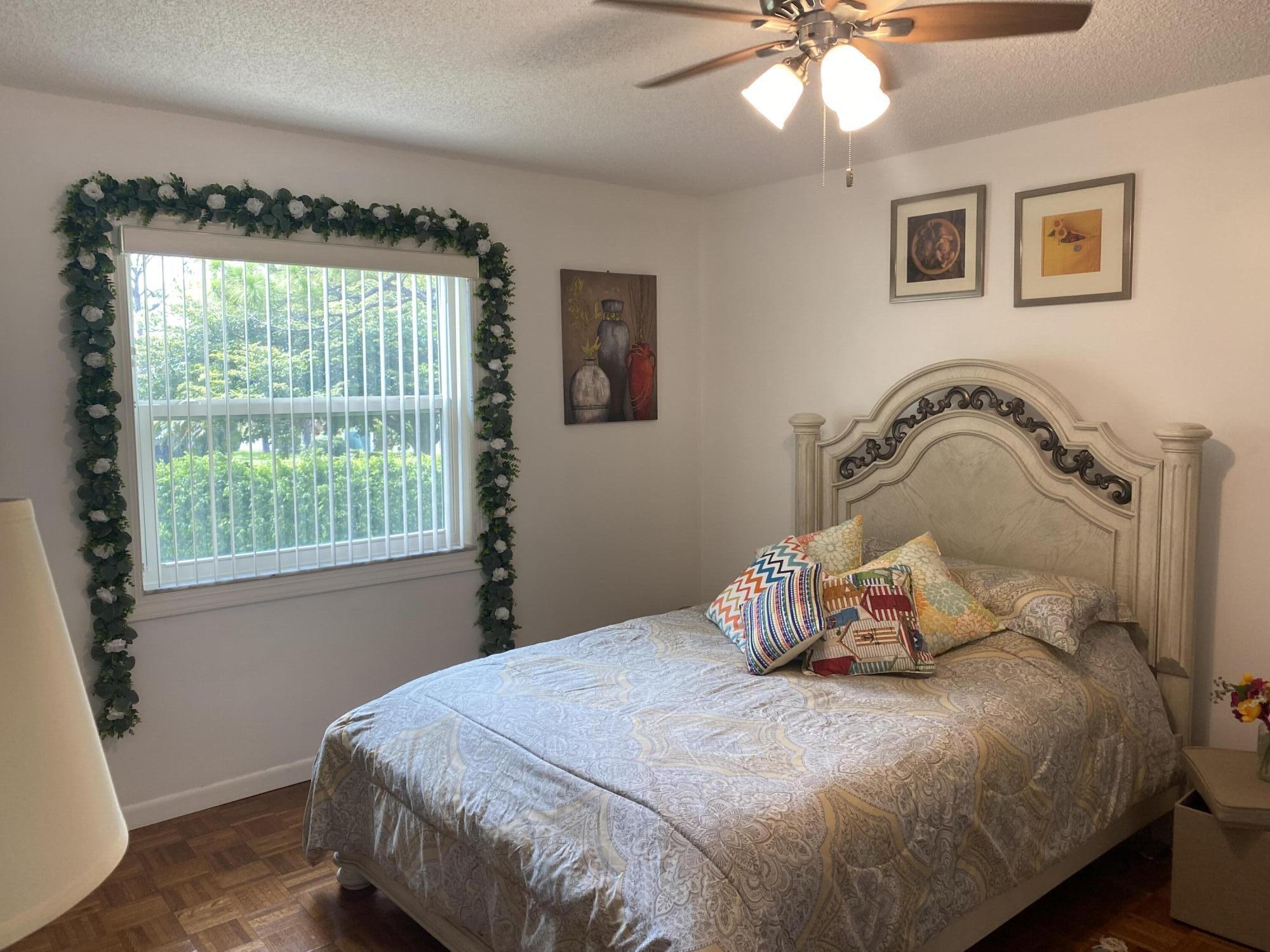 1121 Cactus Terrace, Unit 202 Delray Beach, FL 33445 - Photo 26 of 31 a bedroom with a bed and window