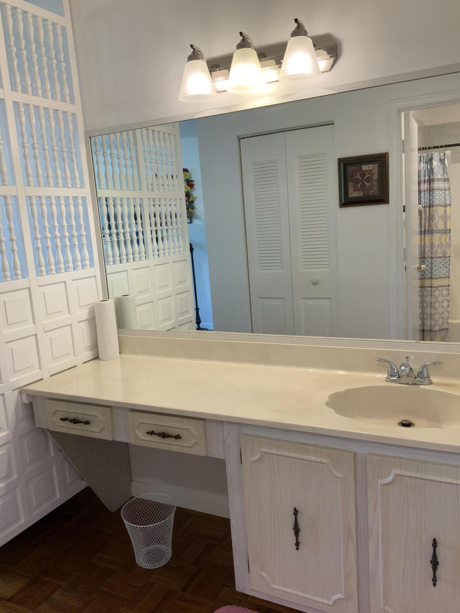 1121 Cactus Terrace, Unit 202 Delray Beach, FL 33445 - Photo 29 of 31 a bathroom with a sink and a bathtub