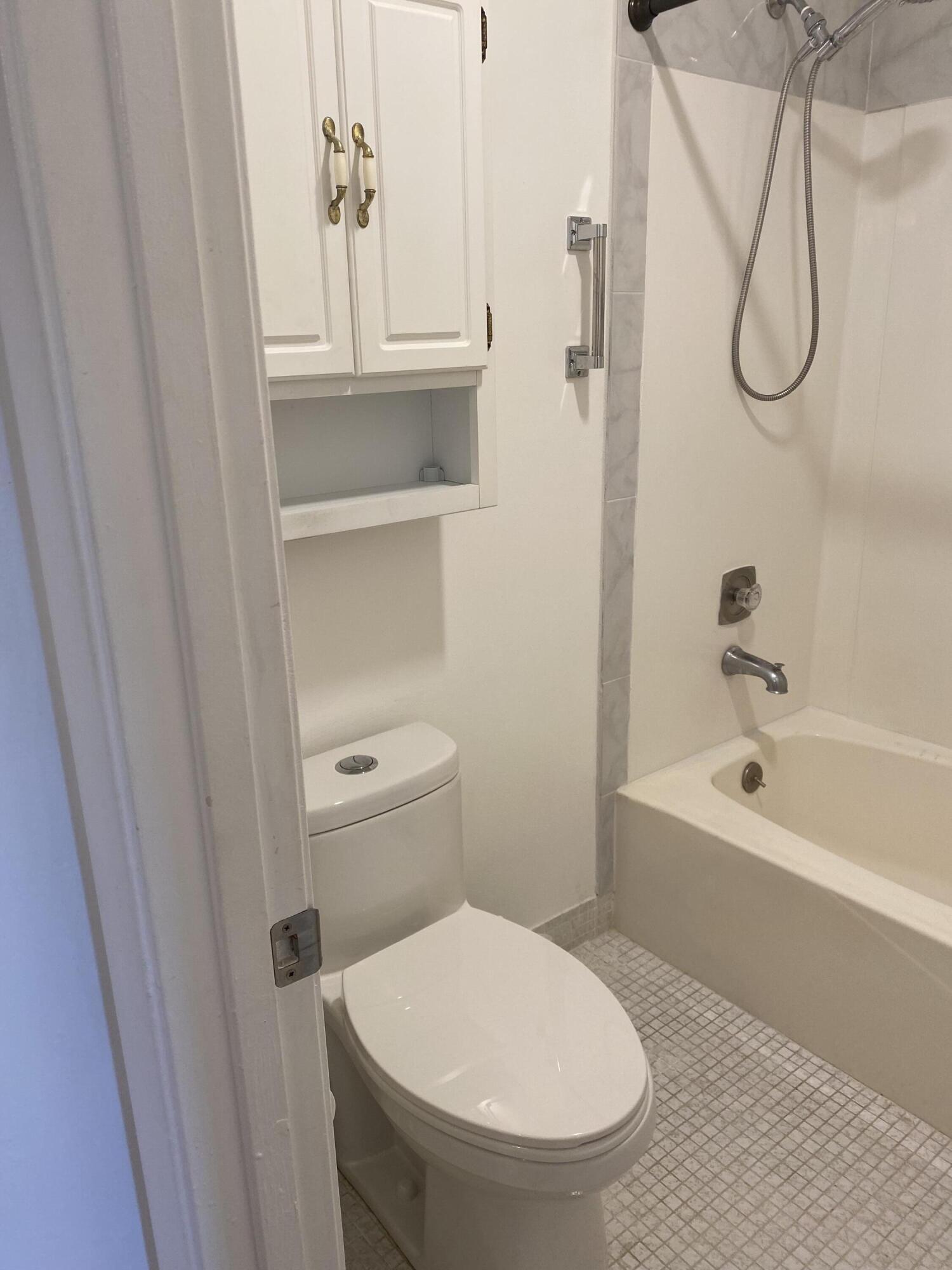 1121 Cactus Terrace, Unit 202 Delray Beach, FL 33445 - Photo 30 of 31 a bathroom with a toilet and a bathtub