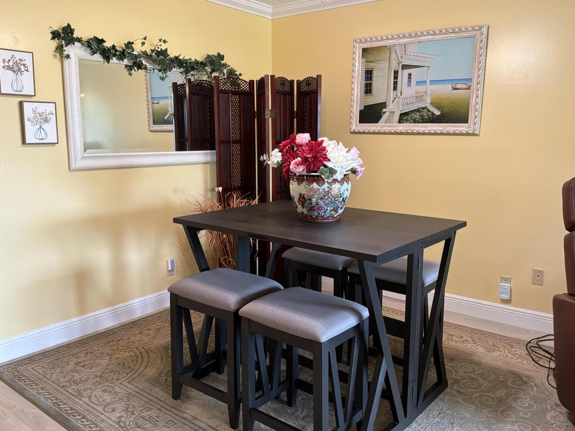 1121 Cactus Terrace, Unit 202 Delray Beach, FL 33445 - Photo 5 of 31 a view of a dining room with furniture and chandelier