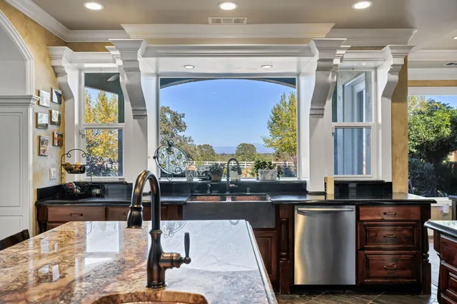 a view of a dining room with furniture a chandelier and a rug