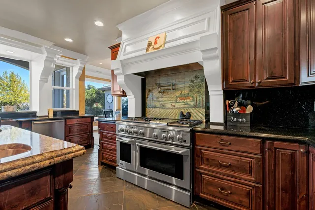 a view of a dining room with furniture and chandelier